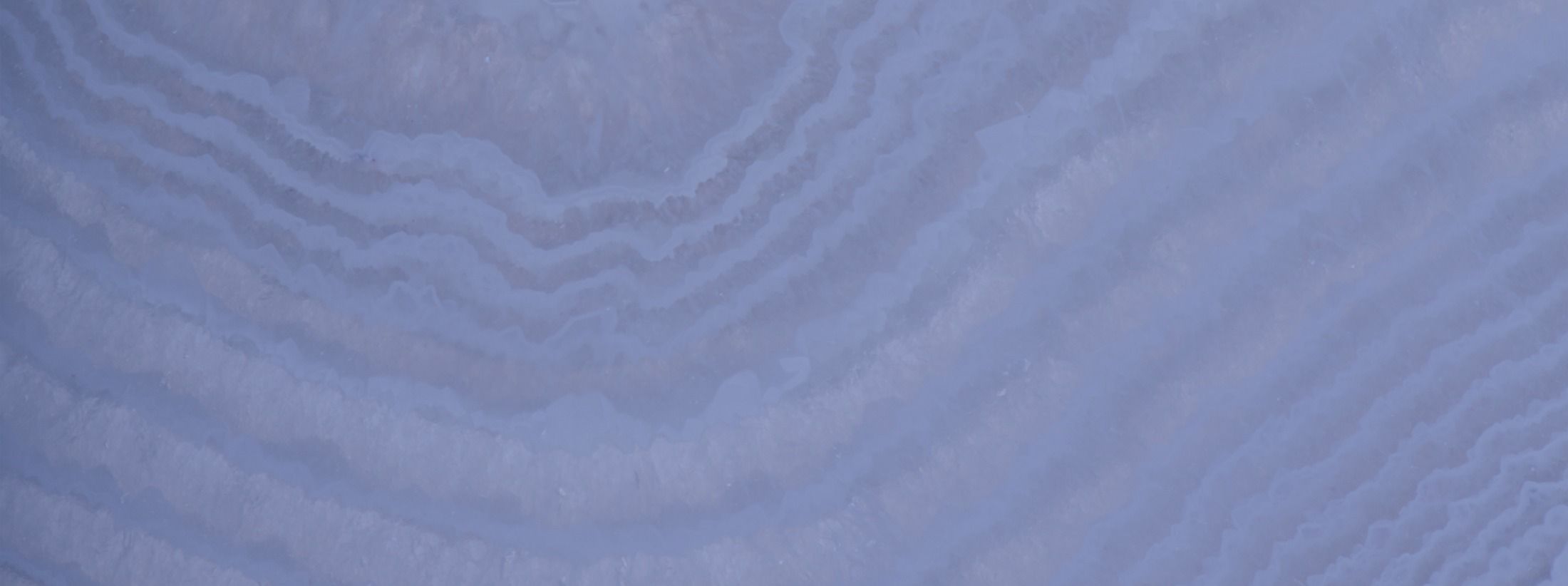 Layered blue and white textured surface background.