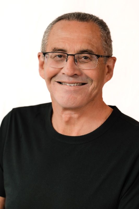 Smiling middle-aged man in black shirt