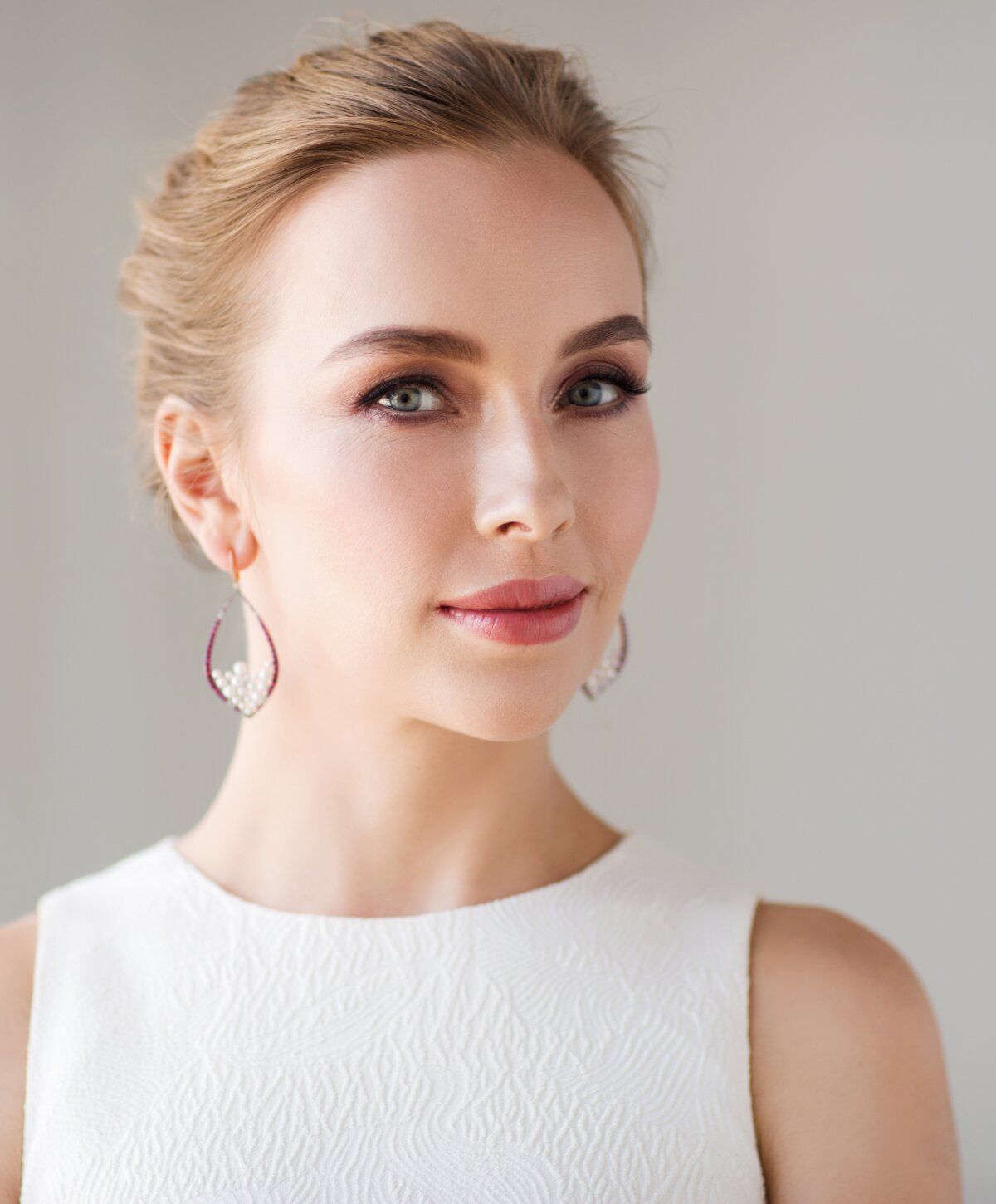 Woman with elegant makeup and stylish earrings.