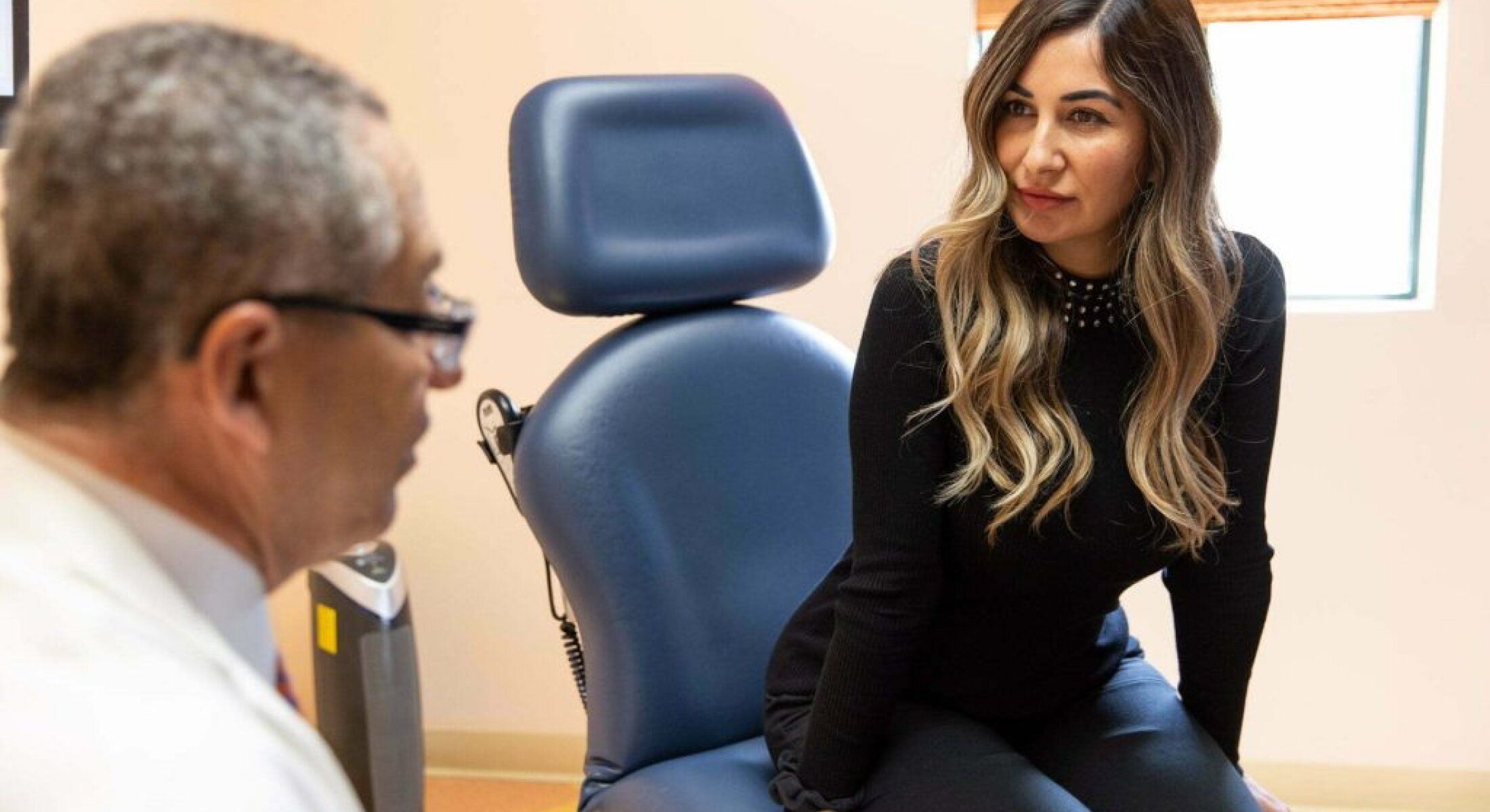 Patient consulting with a healthcare professional in clinic.